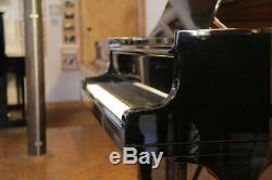 A 1974, Steinway Model B grand piano with a black case. Made in Hamburg