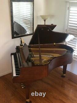 Six foot walnut Everett grand piano. Mint condition. Original owner