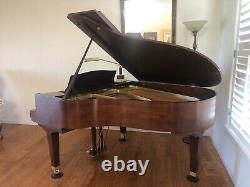 Six foot walnut Everett grand piano. Mint condition. Original owner